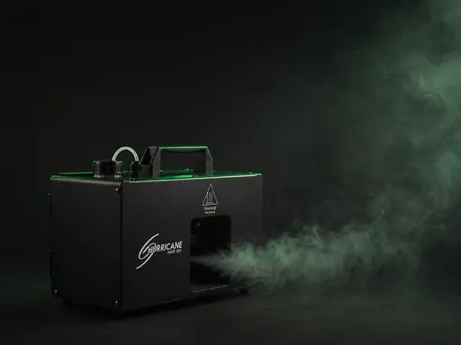 Compact hazer unit emitting a controlled green-tinted haze plume